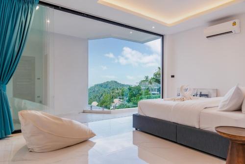 a bedroom with a bed and a large window at Sea View Chaweng Noi Villa Luxury in Chaweng Noi Beach