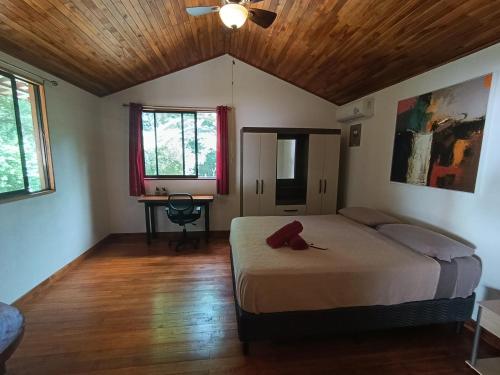 a bedroom with a bed with a stuffed animal on it at Aura Bungalow in Tamarindo