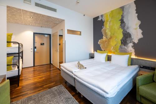 a bedroom with a bed with a painting on the wall at Comfort Hotel Sello in Espoo