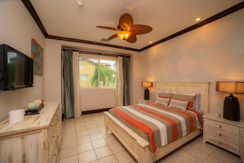 a bedroom with a bed and a ceiling fan at Vista Bahia 3C 3 bdr Ocean View in Los Suenos in Herradura