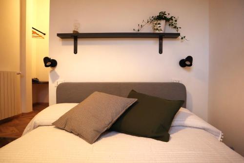 a bedroom with a bed with a shelf on the wall at B&B Casa Valentina in Rome
