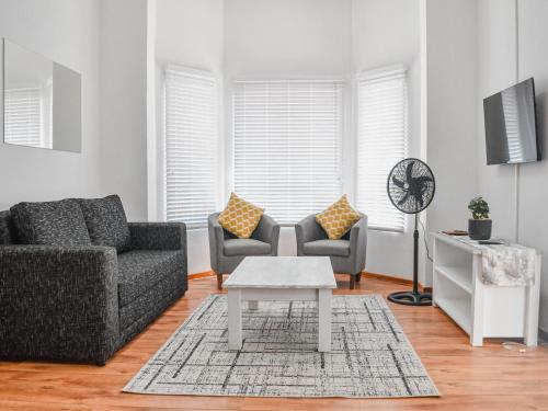 a living room with a couch and a table at Splendid Village in Beaufort West