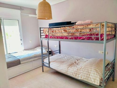 two bunk beds in a room with a mirror at casa Palm Beach in Montroig