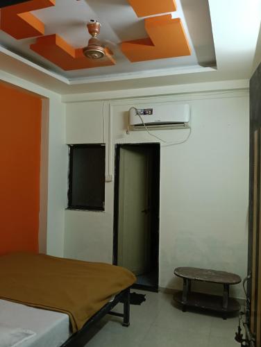 a room with a bed and a ceiling at Sahara yatri niwas in Kolhapur