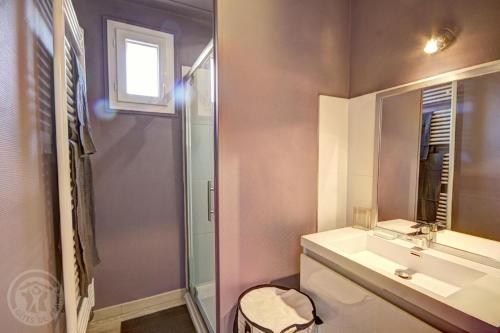 a bathroom with a toilet and a sink and a mirror at Le sorberan in Sorbiers