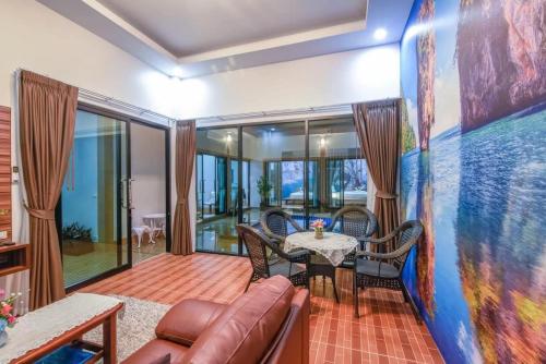a living room with a table and chairs at Cocoloco Pool Villa Ao nang in Ban Khlong Son