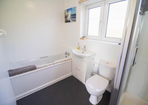 een badkamer met toilet, wastafel en bad bij Marine Villa By Air Premier in Saltdean