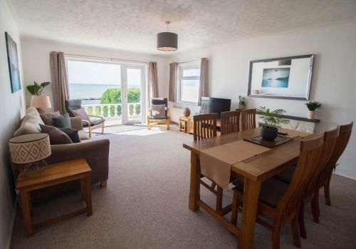 a living room with a table and a couch at Marine Villa By Air Premier in Saltdean