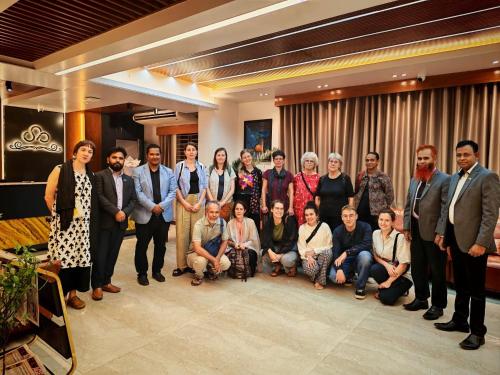 a group of people posing for a picture in a lobby at Sylhet Paradise Inn in Sylhet
