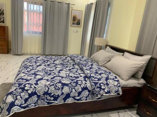 a bedroom with a bed with a blue and white blanket at BethelAirbnb 