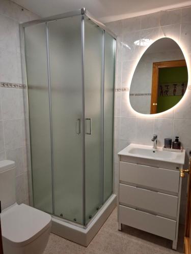 a bathroom with a shower and a toilet and a sink at Stylish Apartment in Villajoyosa