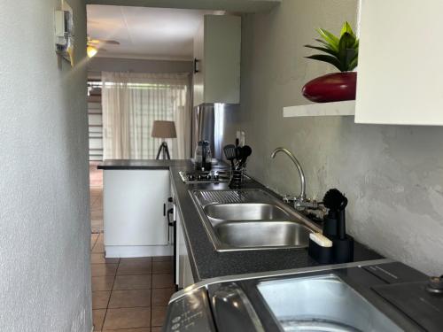 a kitchen with a sink and a counter top at Tana's flat in Brakpan