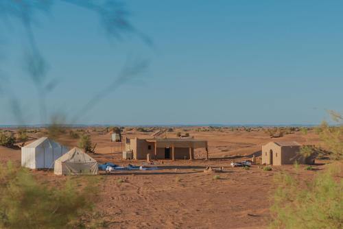 a group of tents in the middle of a desert at Silent Camp in Mhamid