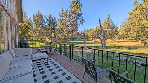 a patio with a couch and chairs on a balcony at Red Wing Nest home in Redmond