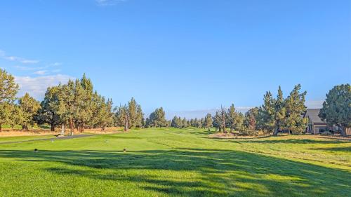 a view of a golf course with trees and a green at Red Wing Nest home in Redmond
