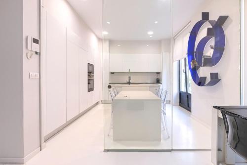 a kitchen with white cabinets and a blue circle on the wall at Apartamento Bilbo in Bilbao