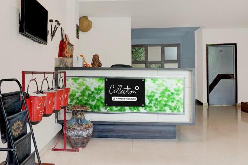 a large television in a living room with a vase at Super Collection O Vaishno Devi Temple Formerly Hotel The Leaf in Katra