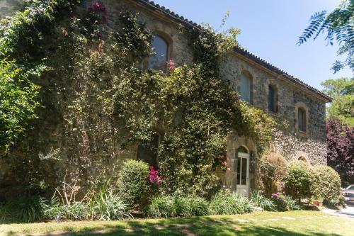 an old stone building with flowers on it at Collina Blu - Umbria - Lago di Bolsena in Bolsena
