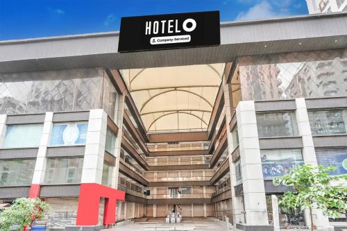 a building with a hotel sign on it at Super Hotel O Sneh Rashmi Botanical Garden Surat Formerly Stadium Plaza in Bhatha