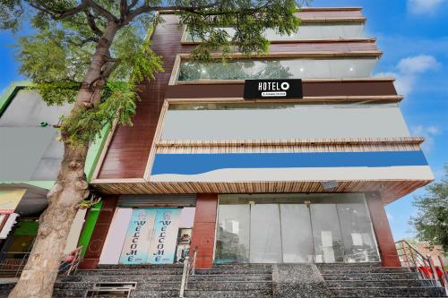 a building with a sign for a hotel at Townhouse Sheesh Mahal Farrukh Nagar in Farrukhnagar