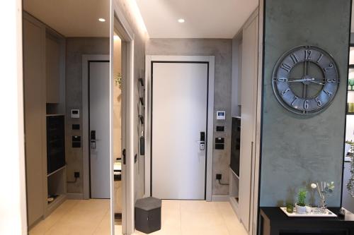 a hallway with a large clock on the wall at KRUNA 406 Apartment in Budva