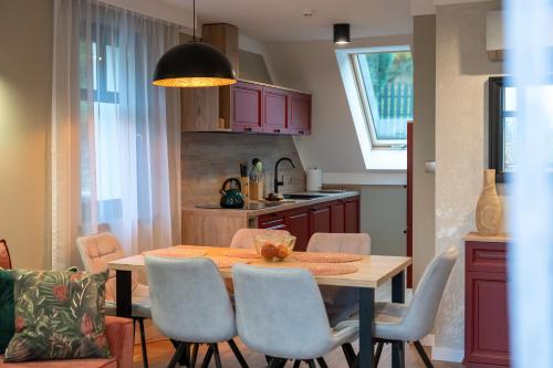 a kitchen and dining room with a table and chairs at Willa Bukowy Las - Everslow in Szklarska Poręba