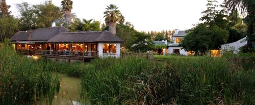 a building with a lot of lights in a field at Woodall Country House and Spa in Addo