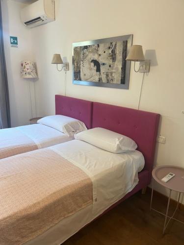 a hotel room with two beds and a table at SelfMatic in Orio al Serio