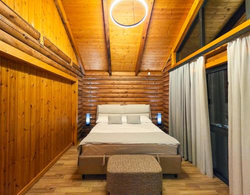 a bedroom with a bed in a wooden room at Karpet Dilijan in Dilijan