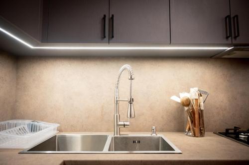 a kitchen counter with a sink and a faucet at Karpet Dilijan in Dilijan
