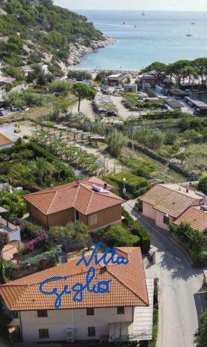 an aerial view of a building with blue graffiti on it at Case vacanza Barbatoja in Fetovaia