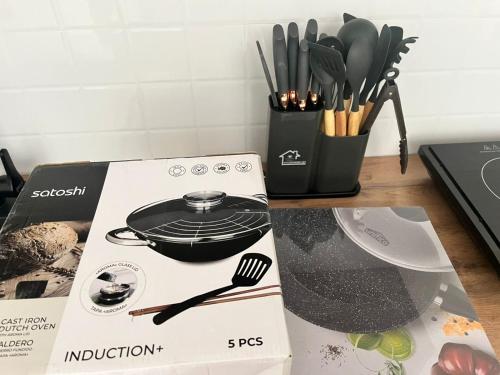 a box on a table with a pan and a knife and fork at TESTkg in Cholpon-Ata