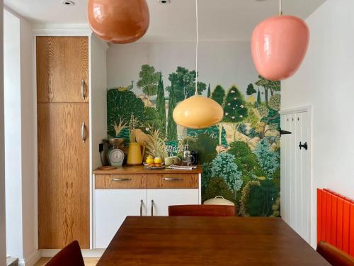 a kitchen with a large painting on the wall at Mid-Century Gem - Heart of Frome in Frome