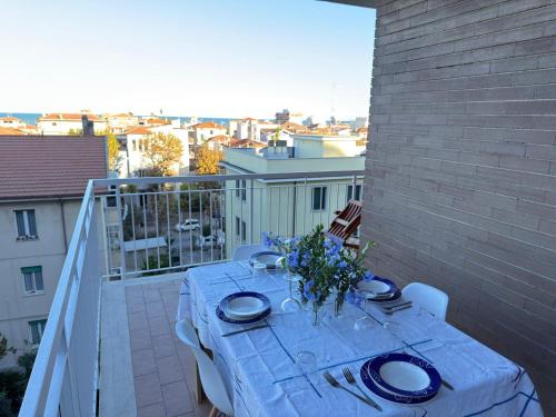 a table on a balcony with a view of a city at Terrazza vista mare-Parcheggio gratuito -3Min A14 -Mastrangelo Beach in Grottammare