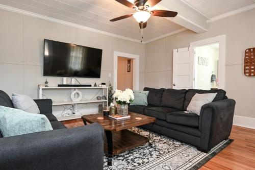 a living room with a couch and a tv at The Bulldog Farmhouse - 100 year old home in Athens