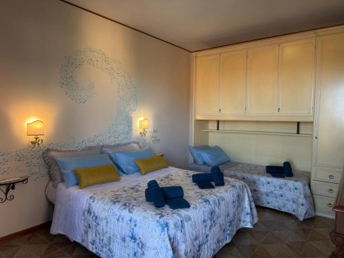a bedroom with two beds with blue comforters at Terrazza vista mare-Parcheggio gratuito -3Min A14 -Mastrangelo Beach in Grottammare