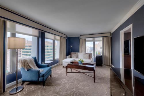 a hotel room with a living room with a couch and a table at Hamilton Hotel - Washington DC in Washington, D.C.