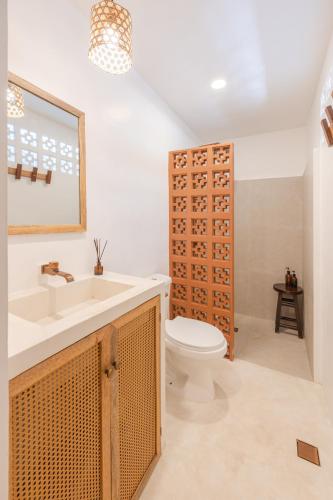 a bathroom with a sink and a toilet at Terracotta House in General Luna