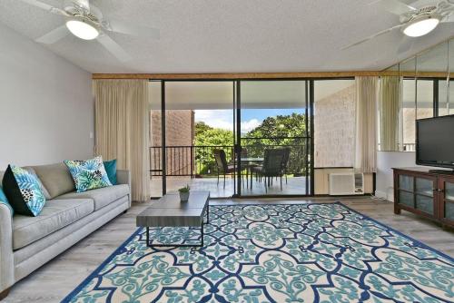 a living room with a couch and a tv at Kihei Alii Kai A207 · KAK A207 Renovated Kihei Condo Near Beach in Kihei