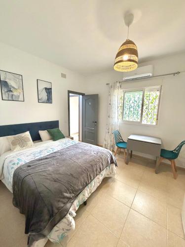 a bedroom with a bed and a desk in it at Luna Ensuites Centro in Málaga