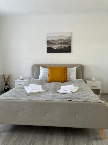 a bedroom with a bed with two towels on it at Gólyafészek Vendégház in Szécsény