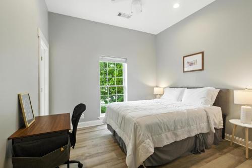 a bedroom with a bed and a desk and a window at NEW LISTING The Classic City Collection - 3 Separate Units in Athens