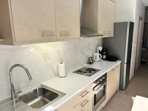 a kitchen with a sink and a refrigerator at Chris3 in Kalamata