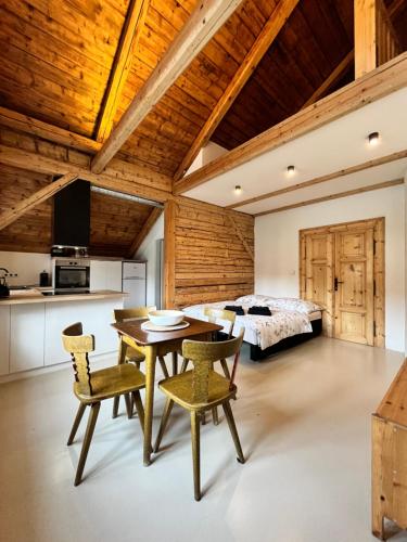 a bedroom with a bed and a table and chairs at Apartmány Bouda 230 in Pec pod Sněžkou