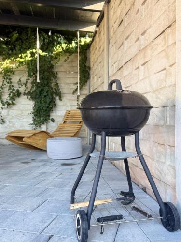 a barbecue grill on a stand on a patio at Apartamenty Gliwicka 12 