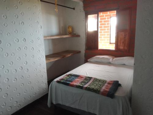 Ένα ή περισσότερα κρεβάτια σε δωμάτιο στο Casa de Descanso La Villa Sanadora