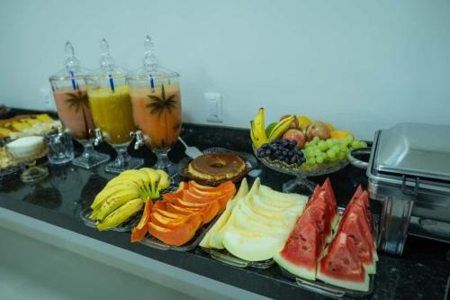 a bunch of different types of fruit on a counter at Hotel Ideal 5 in Araguaína