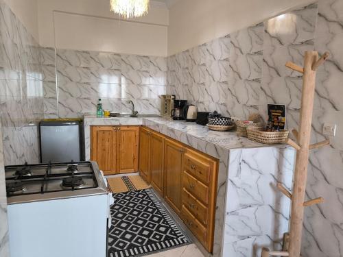 a kitchen with a stove and a counter top at Kaouki beachside apartment - 2 people in Essaouira