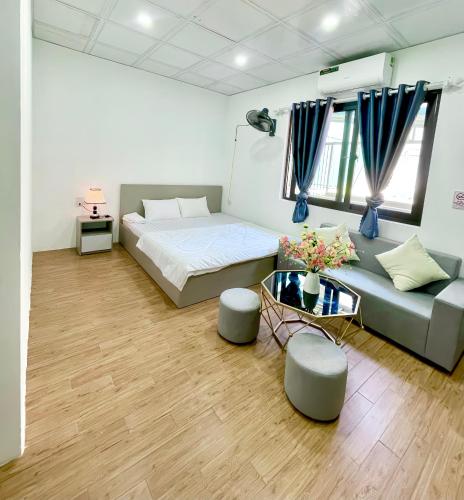 a living room with a bed and a couch at Hotel Diamond in Hanoi