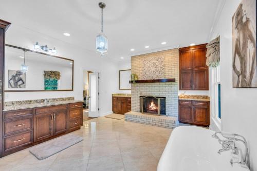 a living room with a fireplace and a couch at The Wexford French Chateau w Pool in Athens
